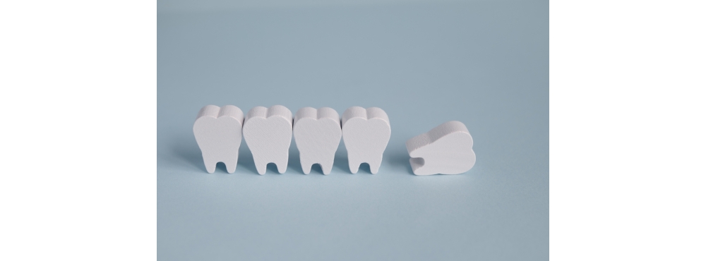 Toy wooden teeth on a blue background.